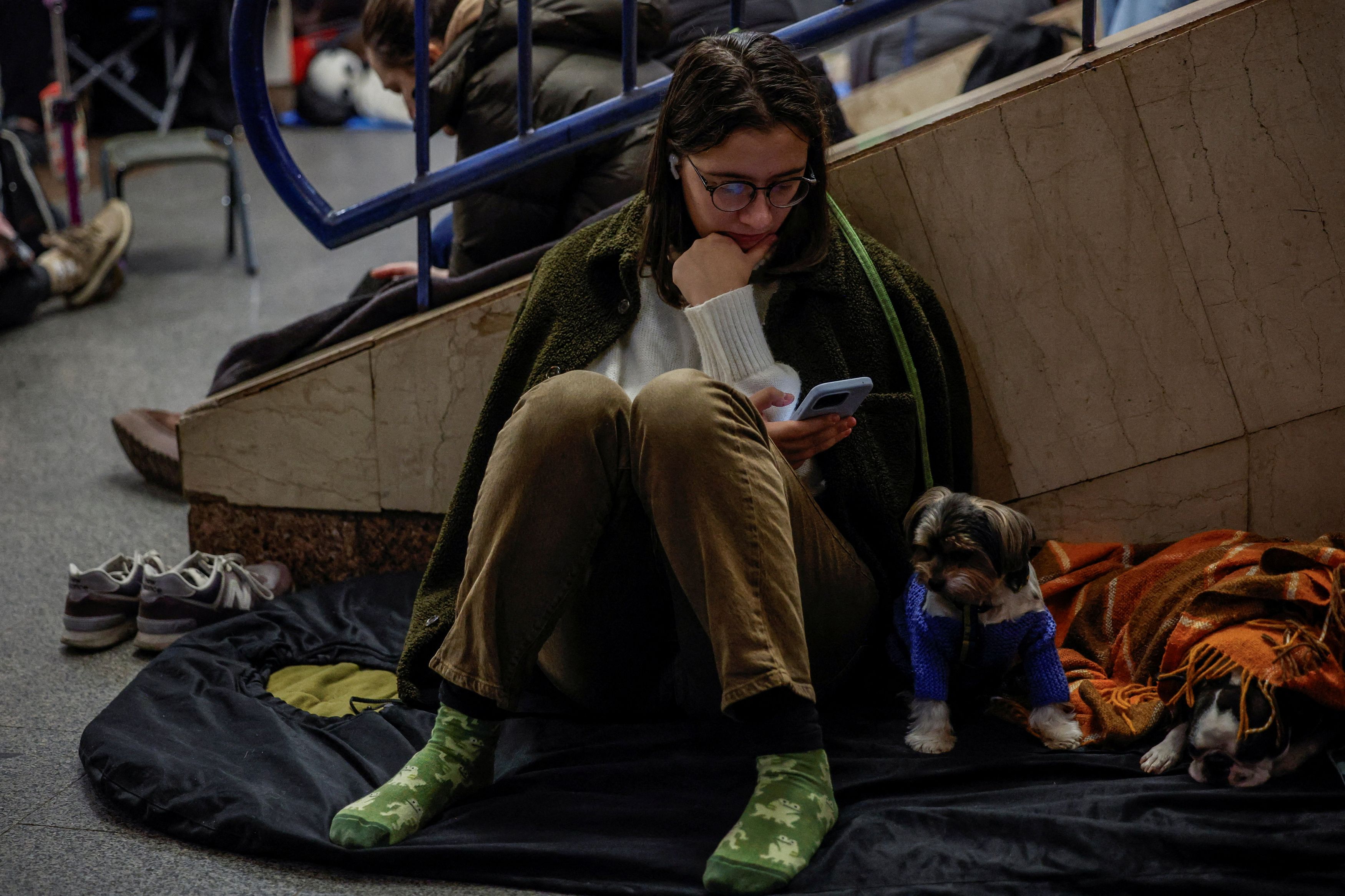 People take shelter inside a metro station during a Russian missile and drone attack, in Kyiv