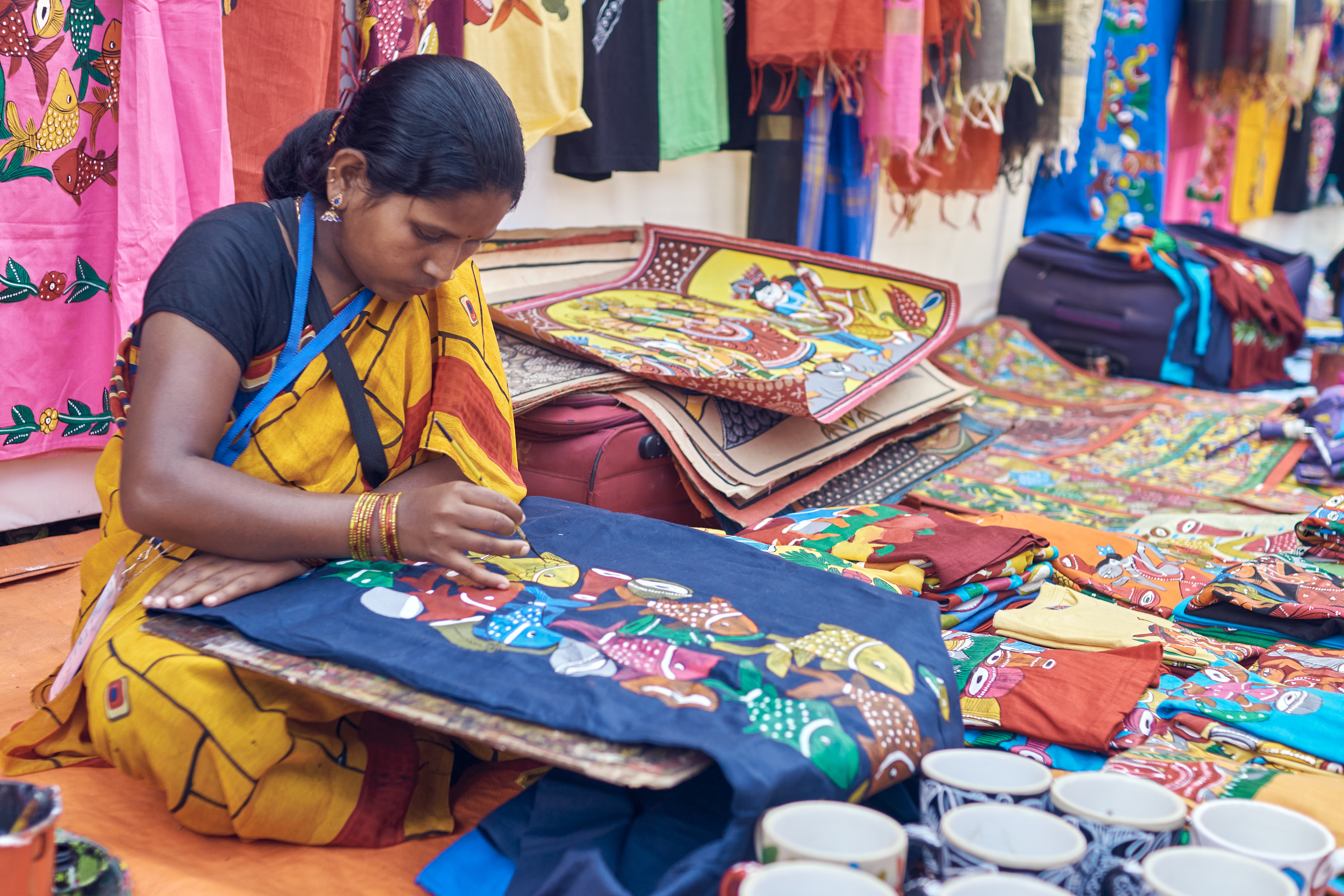 A female artisan busy at work inside Saras Mela fairground, held at Newtown, Kolkata.