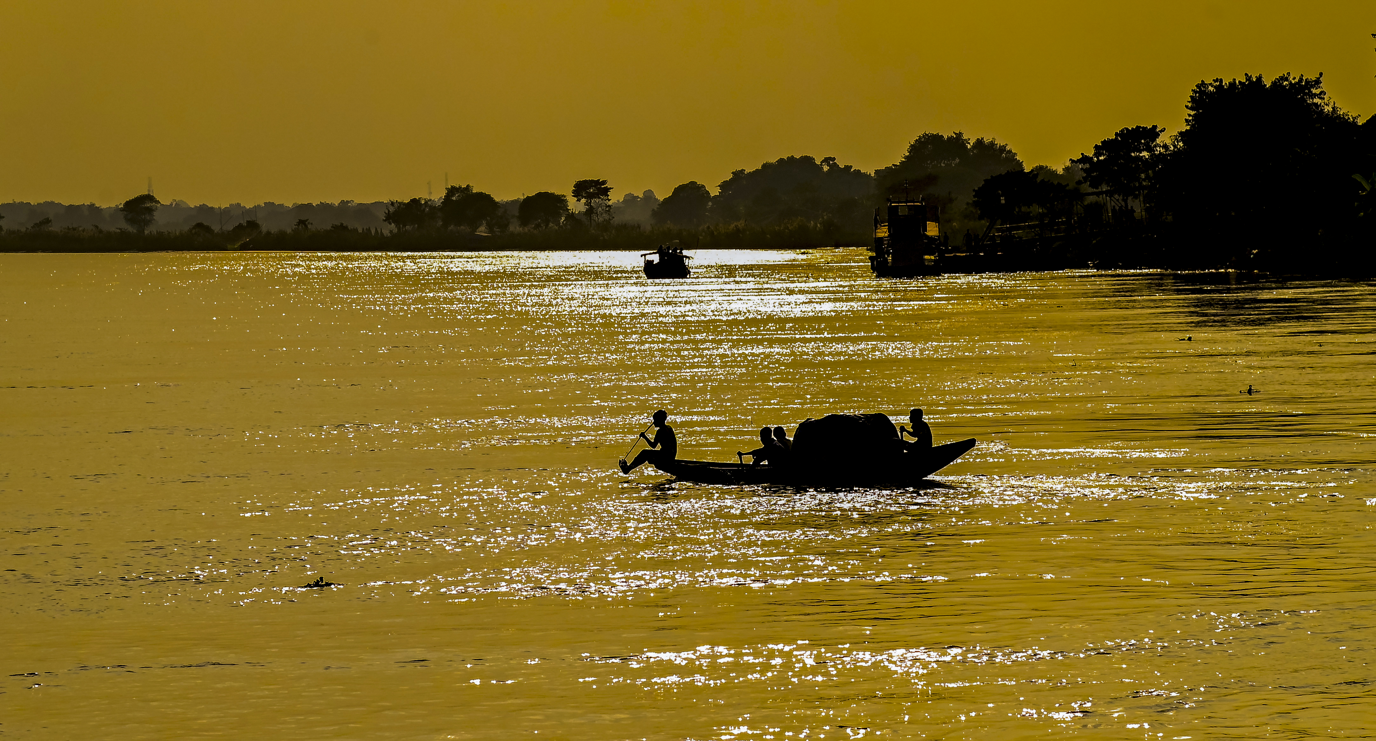 A silhouette of a boatman against the setting sun, in Nadia, West Bengal, Saturday, 