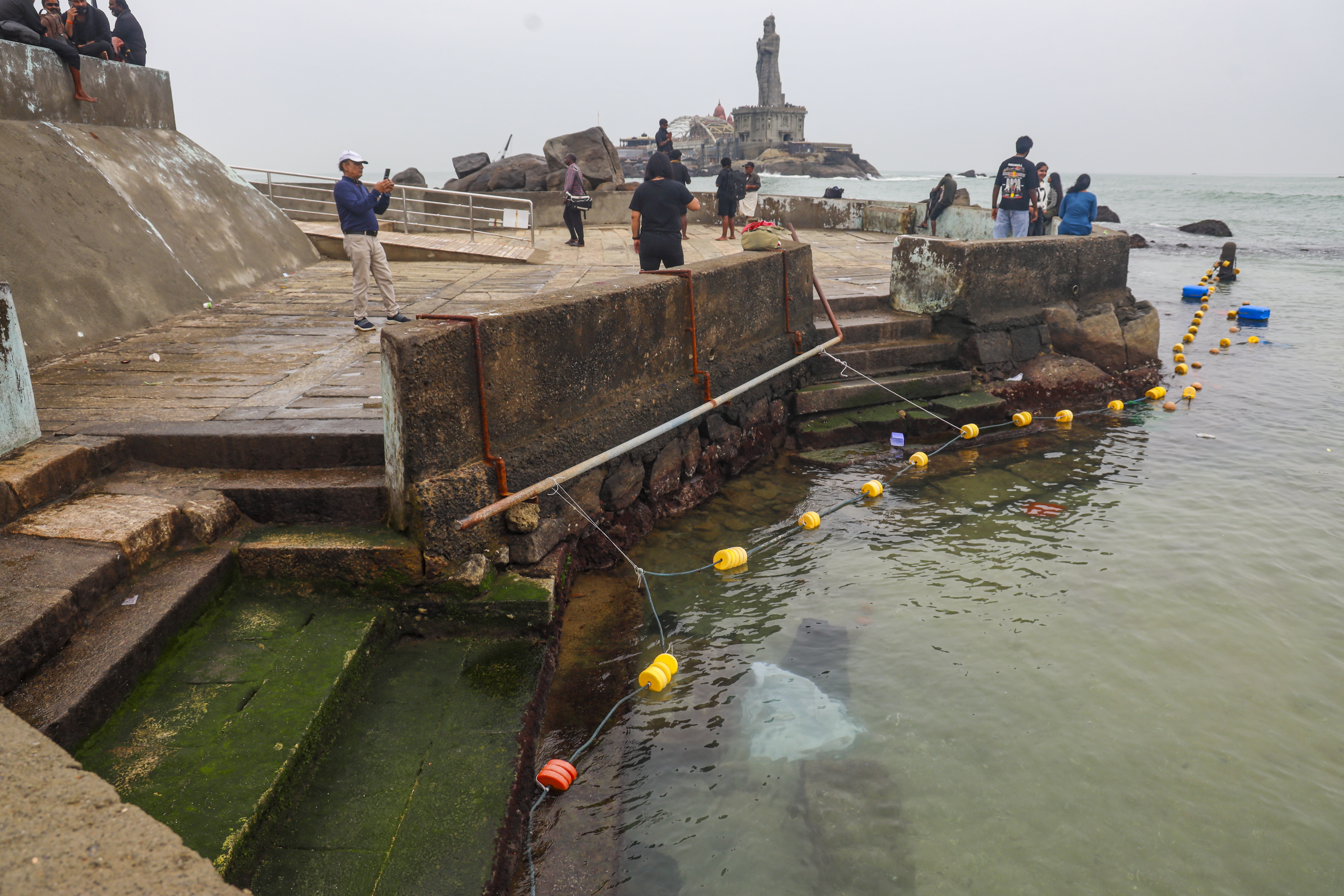 Visitors click pictures as waves crash at the shore, in Kanniyakumari, Tamil Nadu.
