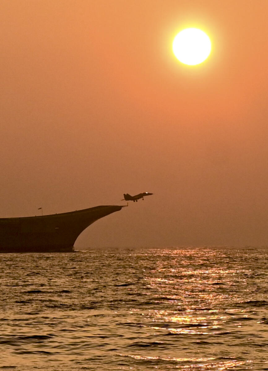 An aircraft takes off from a naval ship during operational demonstration at an event organised as part of the Navy Day celebrations, off the Shangumugham coast in Thiruvananthapuram, Kerala
