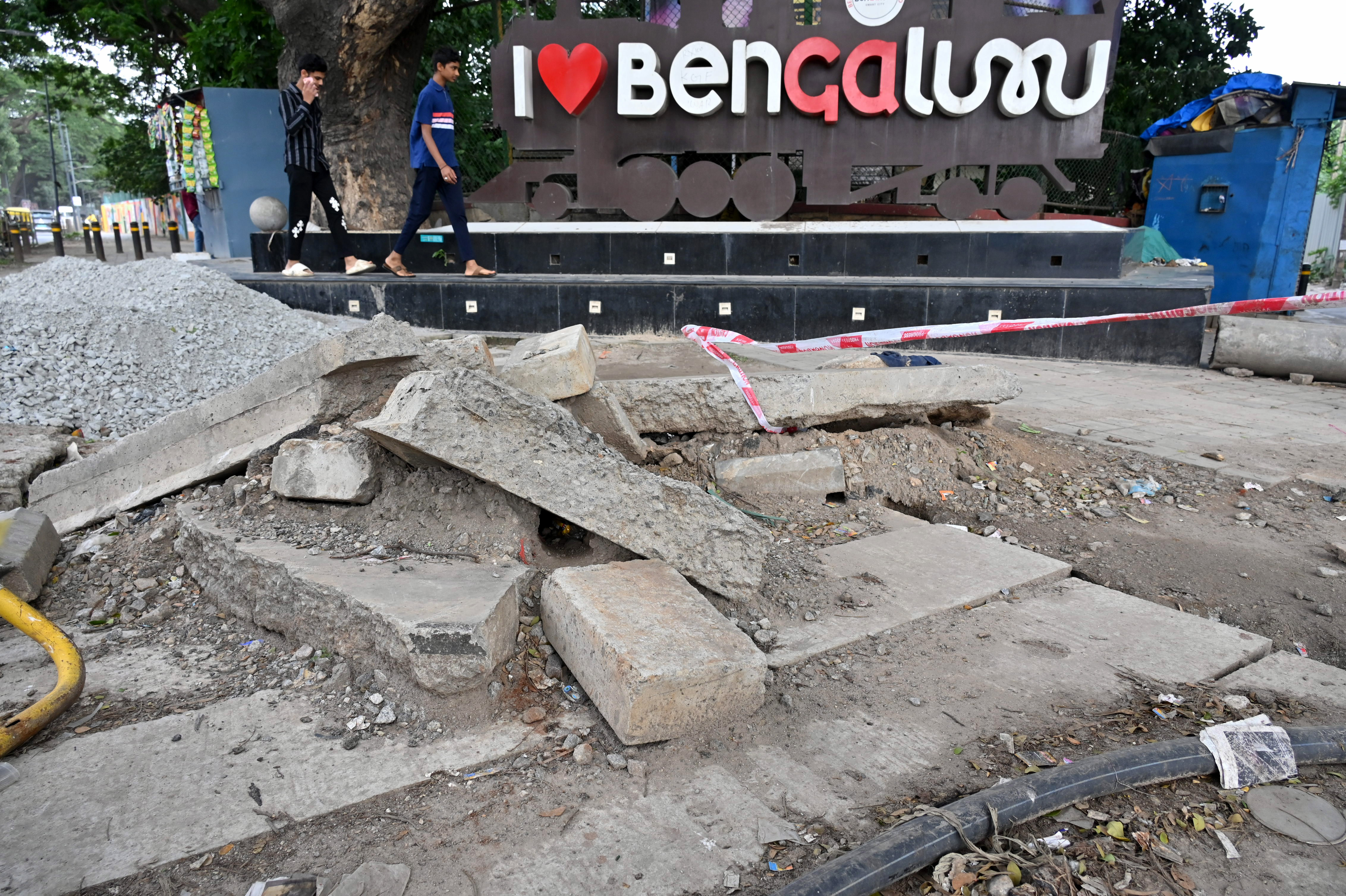 Encroached broken footpaths push pedestrians onto the road. DH FILE PHOTO 