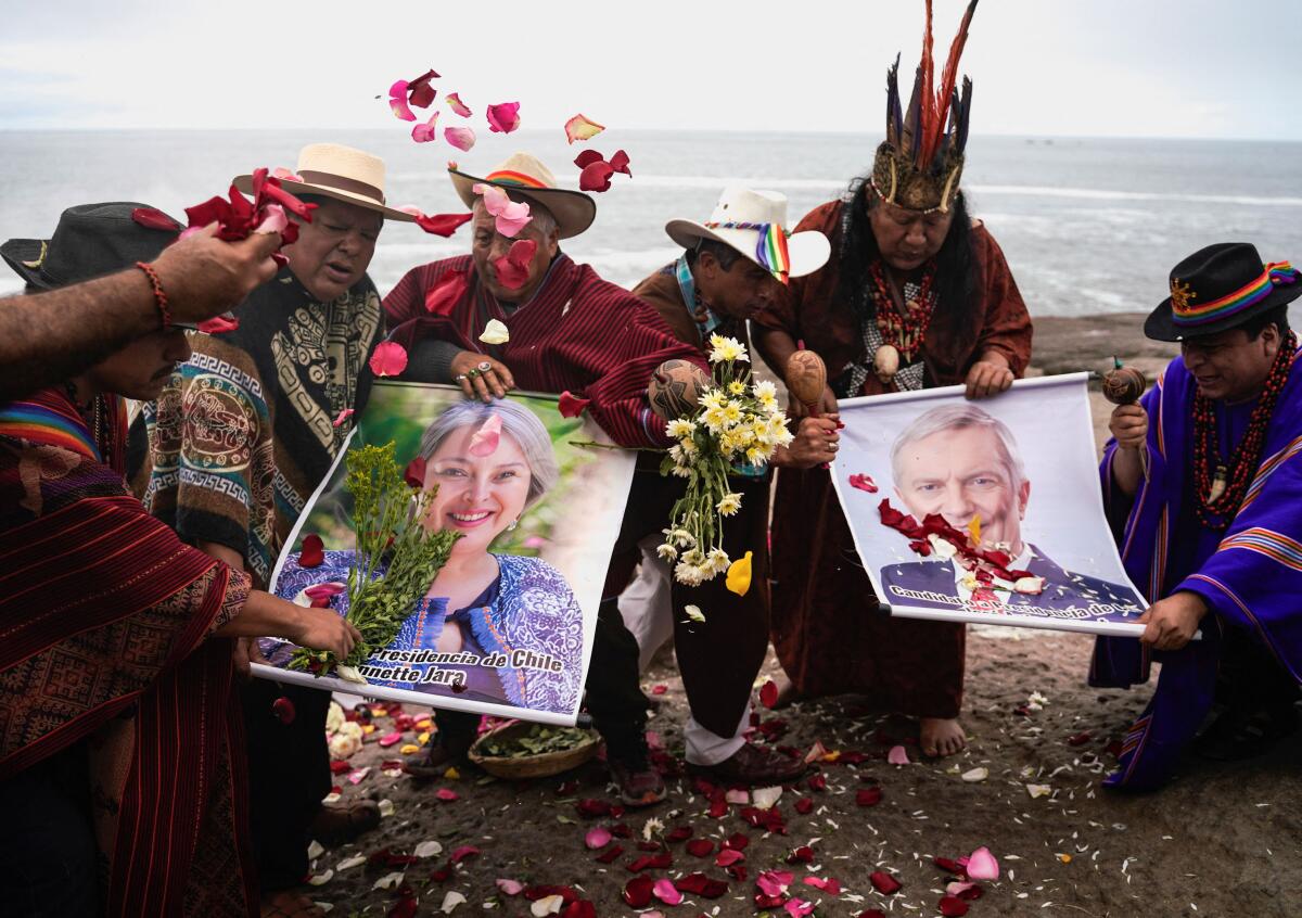Peruvian shamans perform rituals to foresee the outcome of Chile's upcoming December 14 presidential runoff election while holding images of candidates Jeannette Jara, of the ruling leftist coalition and member of the Communist Party, and Jose Antonio Kast, of the far-right Republican Party, in Lima, Peru. Credit: Reuters