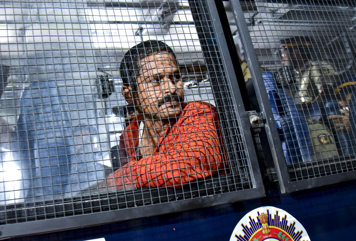 A convict, B. Manikandan sits in a police bus, to be taken from the Ernakulam District Court to jail, in Kochi, Friday, Dec. 12, 2025. Court sentenced six persons convicted in the 2017 actress assault case to 20 years of rigorous imprisonment. Credit: PTI