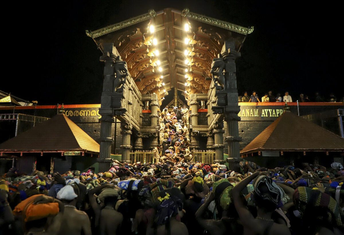Devotees with 'irumudi', a bag carried on head during pilgrimage to Sabarimala temple, in Pathanamthitta, Kerala. PTI