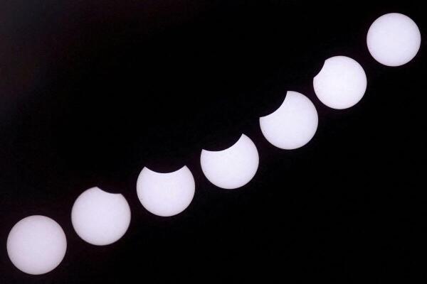 A composite image of 7 separate photographs taken with a single fixed camera shows the a partial solar eclipse seen from Castillo del Romeral, on the island of Gran Canaria. Spain.