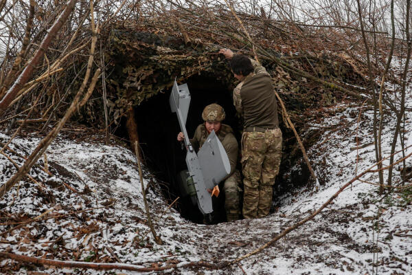 Servicemen of the 66th Separate Mechanized Brigade named after Prince Mstyslav the Brave leave their dugout with a Darts middle range strike unmanned aerial vehicle before launching it towards Russian troops from their position near a front line, amid Russia's attack on Ukraine, in Donetsk region, Ukraine.
