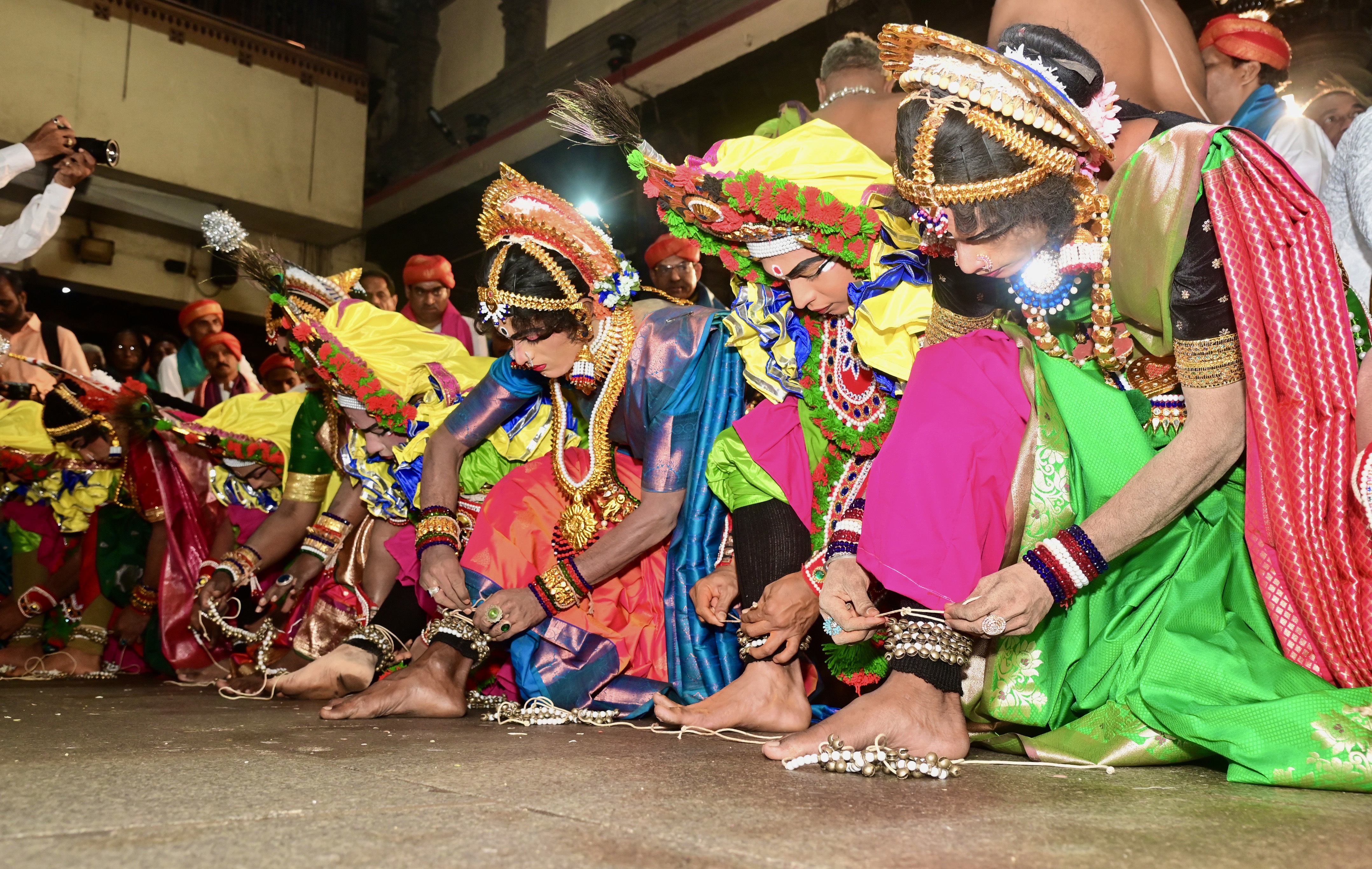 Artistes tie anklets before the Harake Yakshagana tour. 