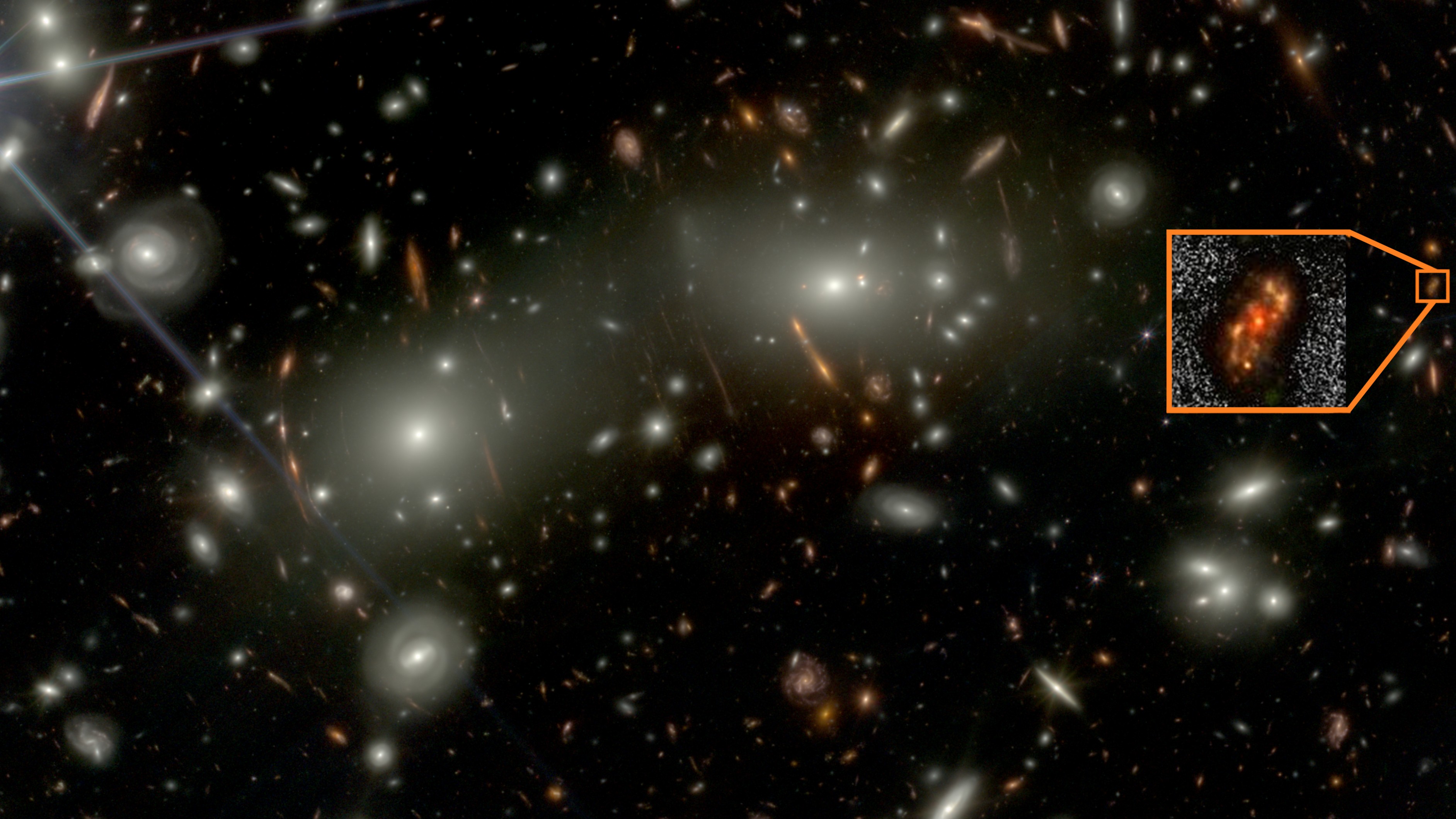 Image of the newly discovered spiral galaxy Alaknanda (inset) as observed in the shorter wavelength JWST bands. Several bright galaxies from the foreground Abell 2744 cluster are also seen.