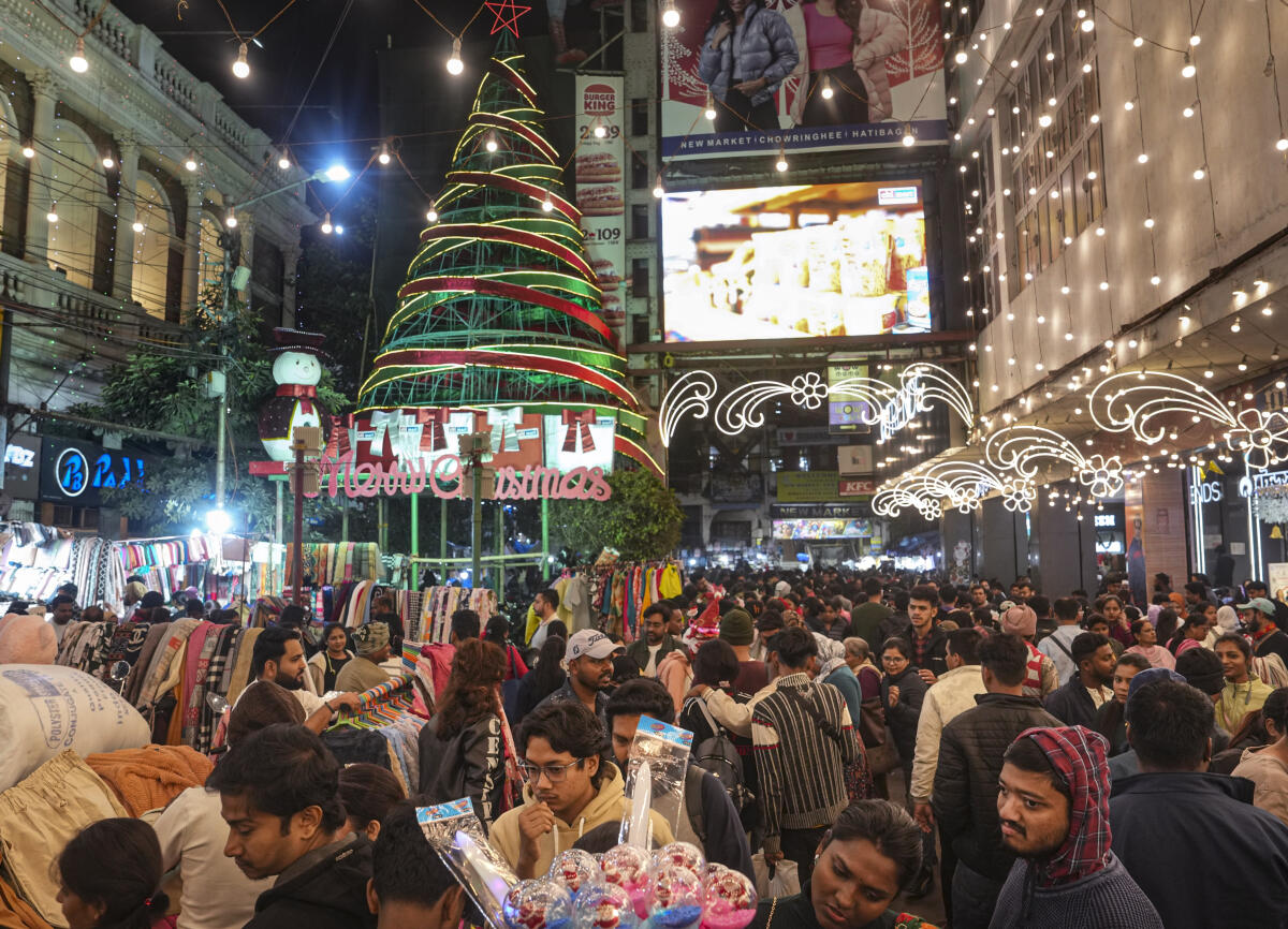 People at a market amid preparations for the Christmas festival, in Kolkata.