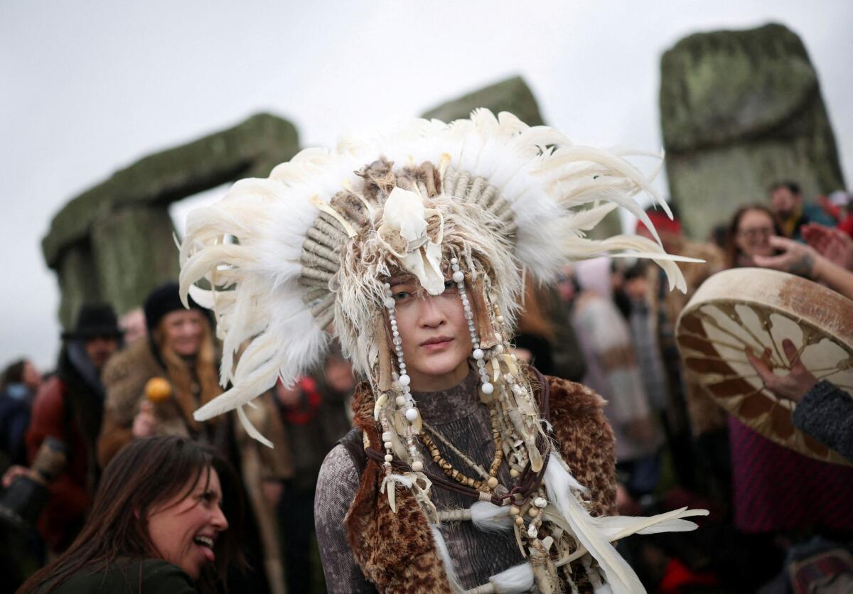 Revellers attend the winter solstice celebrations at Stonehenge stone circle near Amesbury, Britain.