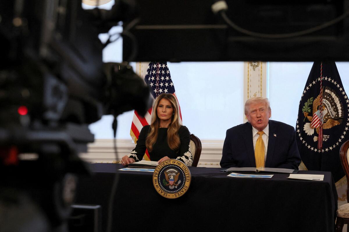 US President Donald Trump and first lady Melania Trump participate in calls to U.S. service members, on Christmas Eve, from the Mar-a-Lago club in Palm Beach, Florida, US.