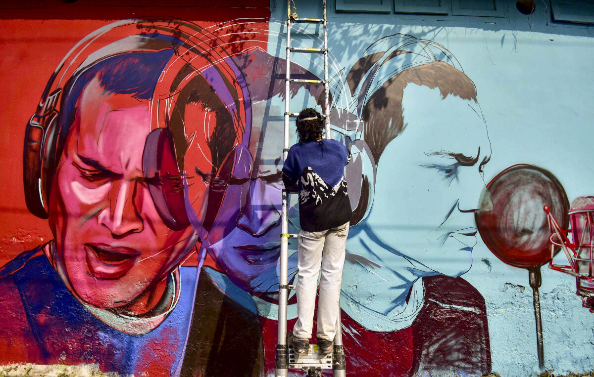 Artist Neelim Mahanta paints a mural of late singer Zubeen Garg as a tribute, in Nagaon district, Assam.
