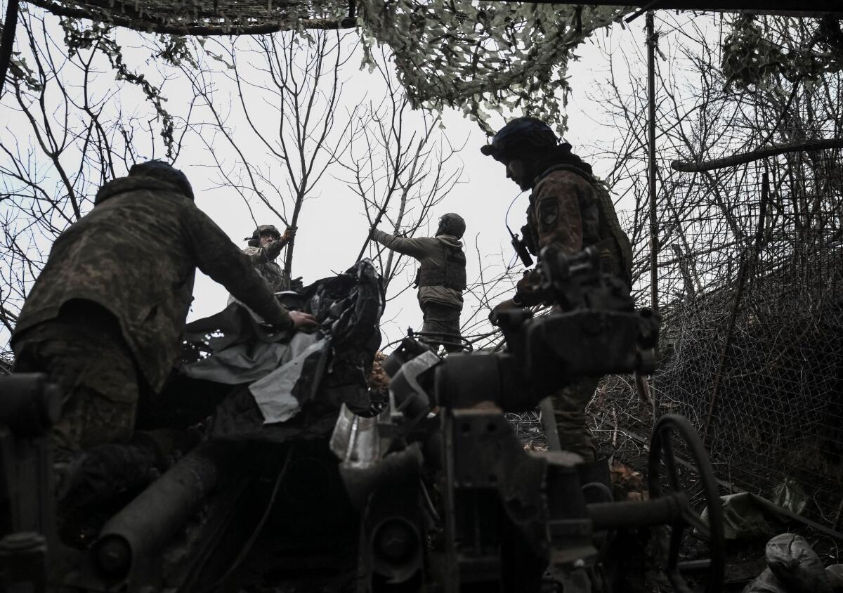 rtillerymen of the 44th Separate Artillery Brigade, named after Hetman Danylo Apostol, of the Armed Forces of Ukraine, camouflage a M777 Howitzer after firing towards Russian troops, amid Russia's attack on Ukraine, in Dnipropetrovsk region, Ukraine.