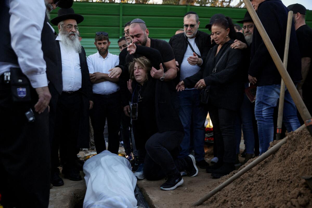 Annie Elkayam, reacts next to the body of her son Dan Elkayam, the 27-year-old French national Jewish man who emigrated to Australia and was killed during a shooting at a Hanukkah event at Sydney's Bondi Beach, during the funeral, in Ashdod, Israel.