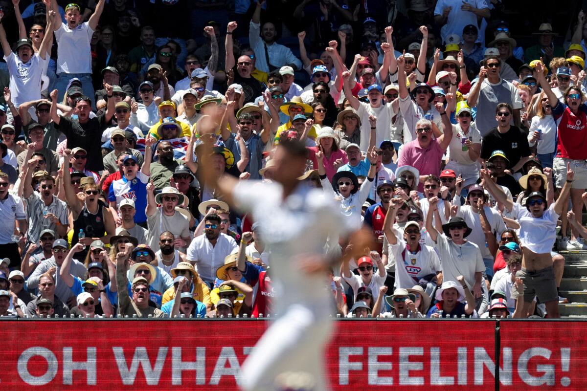 England fans celebrate after England's Josh Tongue gets the wicket of Usman Khawaja of Australia.