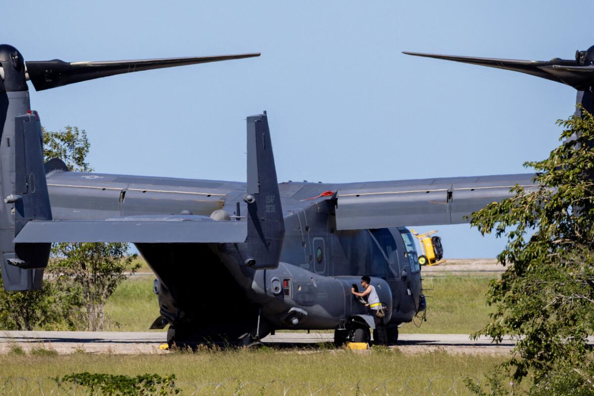 Personnel work on a US Air Force CV-22B Osprey aircraft at Rafael Hernandez Airport, amid tensions between US President Donald Trump's administration and the government of Venezuelan President Nicolas Maduro, in Aguadilla, Puerto Rico