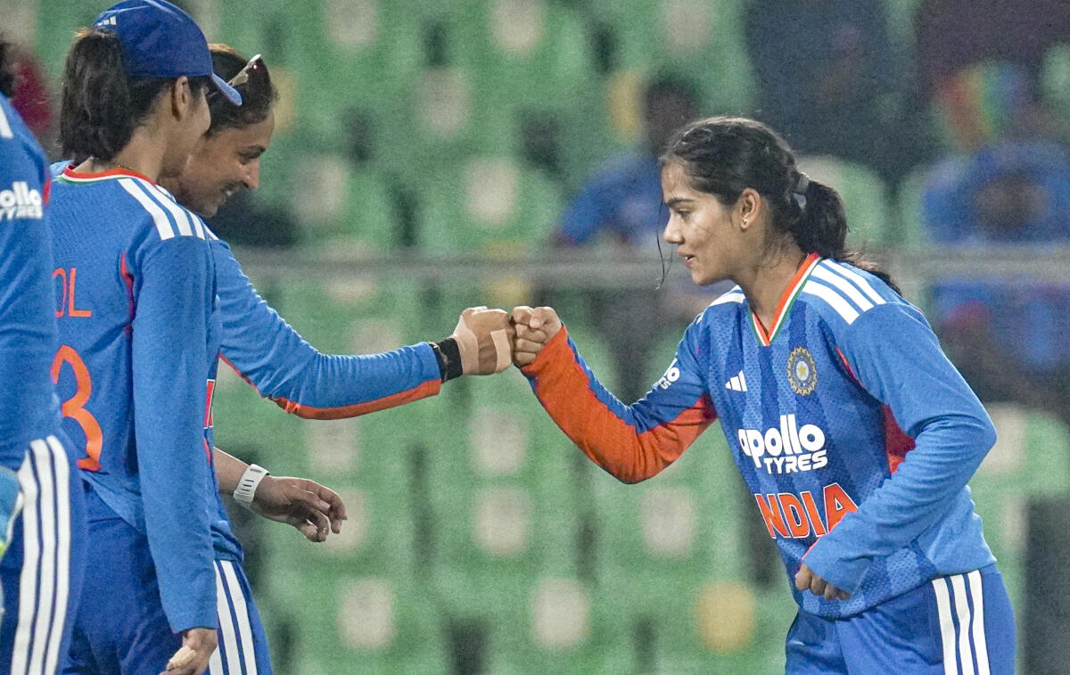 From left, India's Harleen Deol, captain Harmanpreet Kaur and Vaishnavi Sharma celebrate a wicket during the fourth T20 International cricket match of a series between India Women and Sri Lanka Women, at Greenfield International Stadium, in Thiruvananthapuram, Kerala.