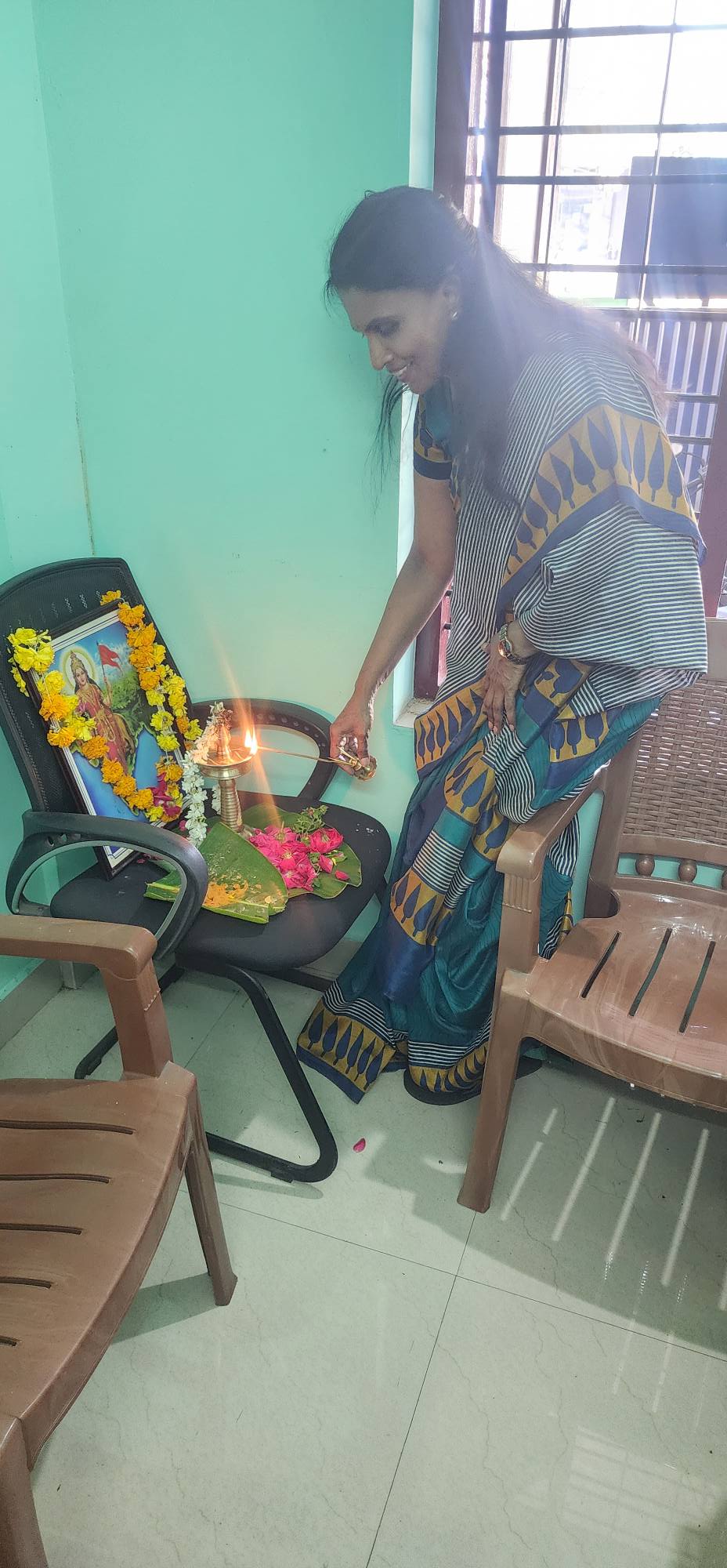 Sreelekha occupies ward councillor's office space by offering prayers in front of a Bharatamba picture. 