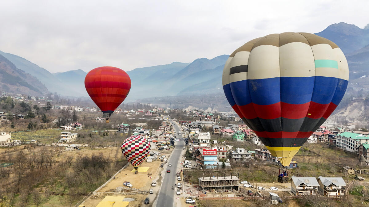 People take hot air balloon rides over the valleys of Manali ahead of the New Year, in Kullu, Monday, Dec. 29, 2025.