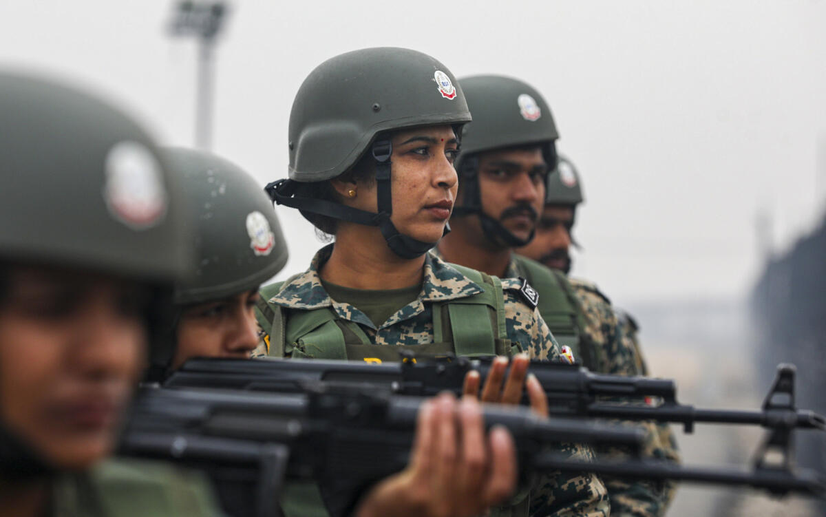 Border Security Force (BSF) personnel patrol near the India-Pakistan international border fence, placed on high alert amid fog and severe cold ahead of New Year to thwart possible infiltration attempts, at Ranbir Singh Pura, in Jammu, Monday, Dec. 29, 2025.
