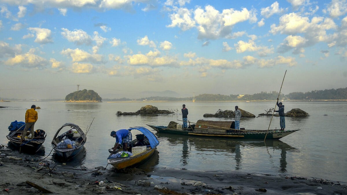 Men park their boats at the Brahmaputra river bank after catching fish, in Guwahati.