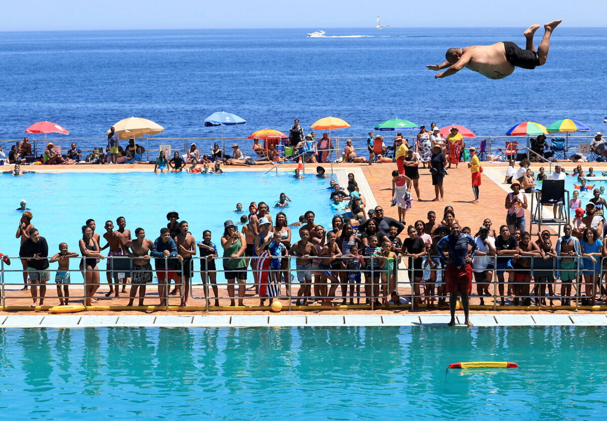 A person dives from a springboard at Sea Point swimming pool in Cape Town, South Africa, December 29, 2025.