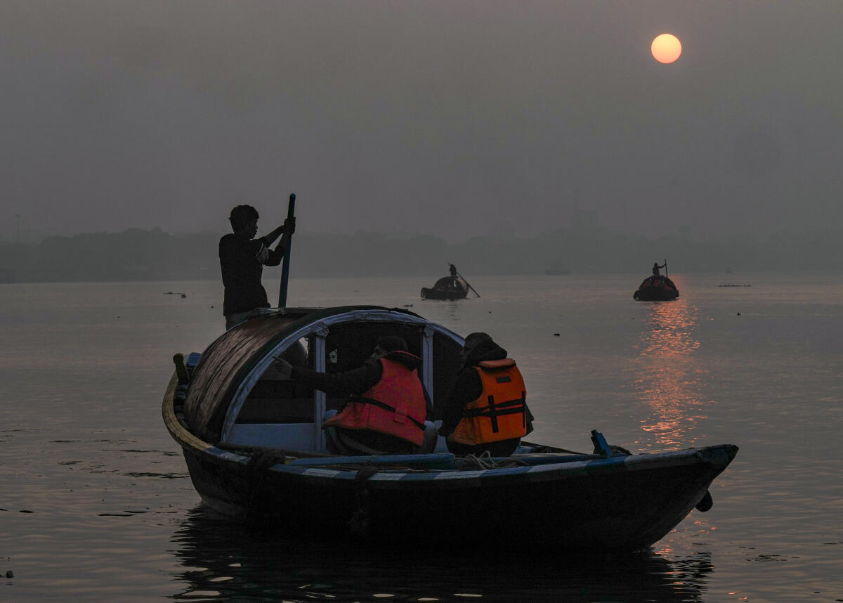 Visitors take boat rides in the Hooghly river during the last sunset of the year, at Princep Ghat, in Kolkata, West Bengal, Wednesday, Dec. 31, 2025.