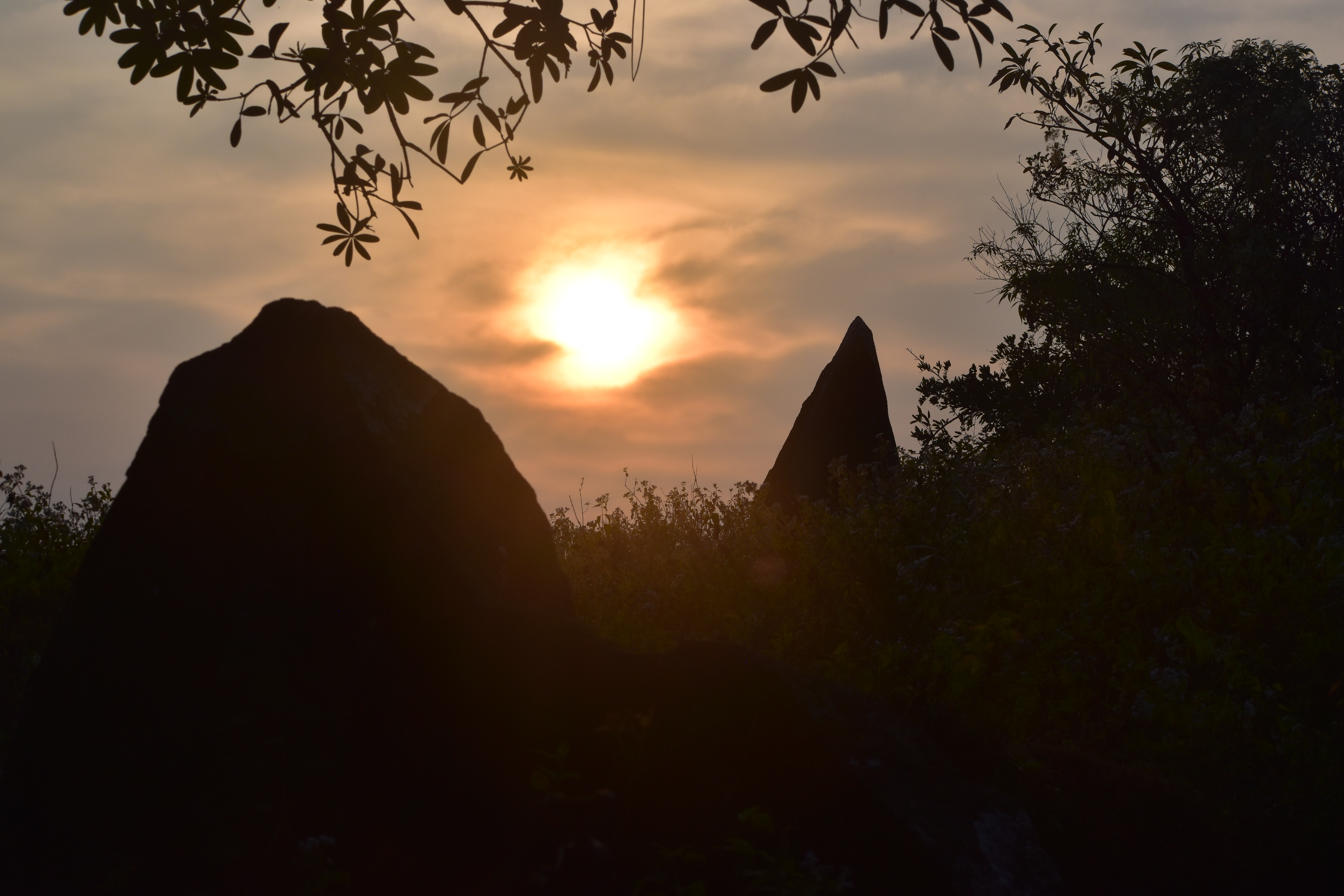 Two menhirs of the stone alignment at Nilaskal framing the setting sun at Winter Solstice. Photo by Srikumar M Menon