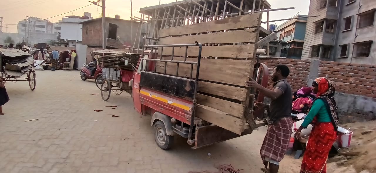 Evicted individuals gather their belongings in a truck