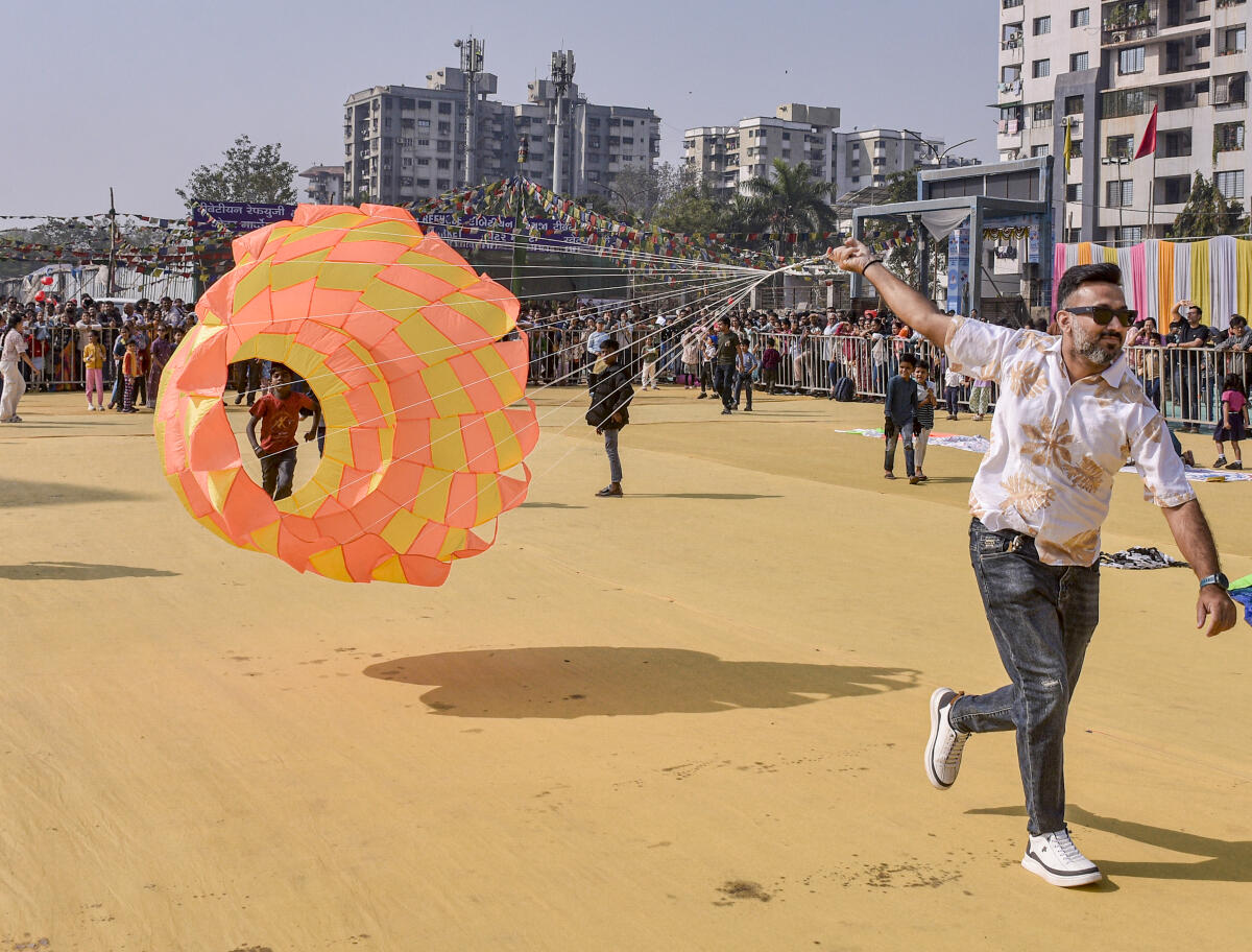 A man flies a kite during the inauguration of ‘International Kite Festival 2026’ organised at Adajan Riverfront, in Surat, Gujarat