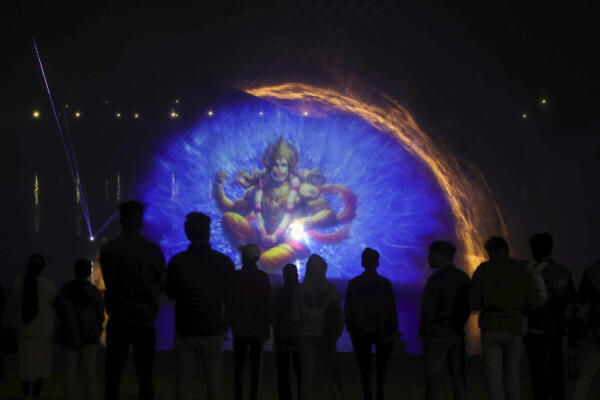 People witness a light show at the bank of River Yamuna during the ongoing Magh Mela 2026, in Prayagraj.