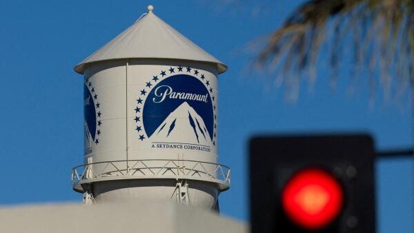 A city street stop sign is shown next to the Paramount water tower at the Paramount studio lot in Hollywood, Los Angeles, California, US.
