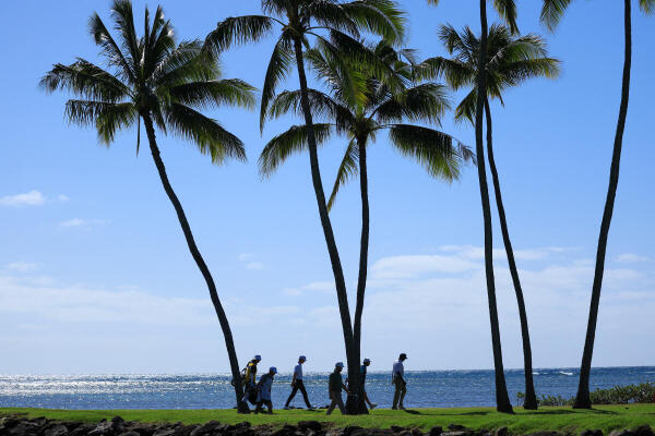 Golfers walk towards the 17th green during the second round of the Sony Open in Hawaii.