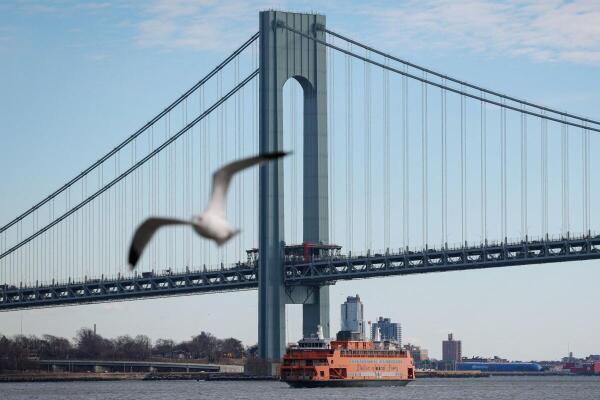The Staten Island Ferry Dorothy Day passes under the Verrazzano-Narrows Bridge as seen from Staten Island.