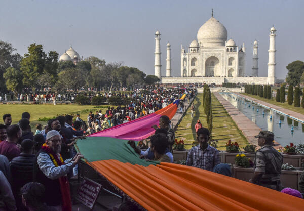 People offer a multi-coloured sheet at the tomb of Mughal emperor Shah Jahan on the concluding day of his Urs (death anniversary), at the Taj Mahal in Agra.