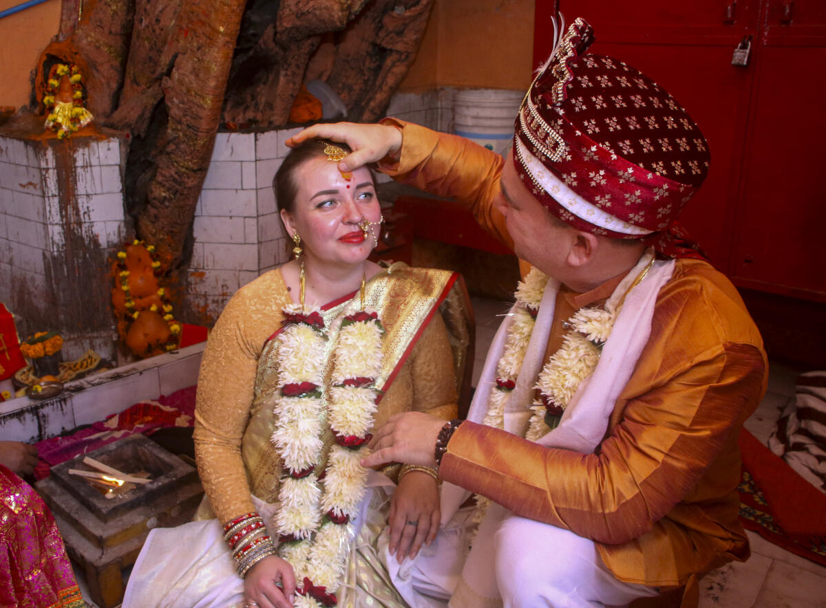 A Russian couple, Konstantin Mering and Marina, perform rituals during a traditional Vedic Hindu wedding ceremony, in Varanasi. PTI