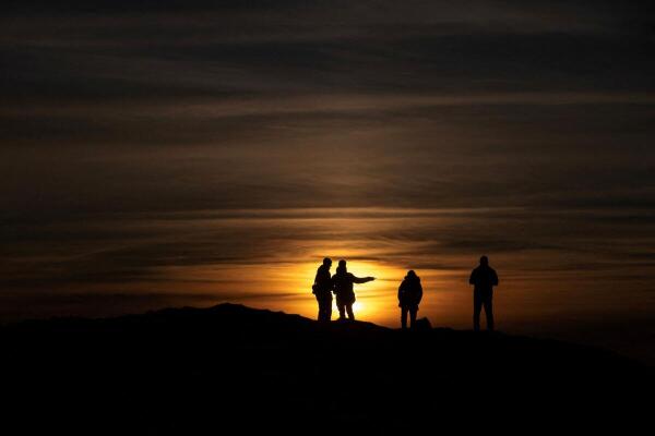 People watch the sunset in Nuuk, Greenland.