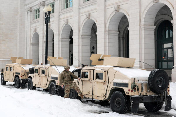 US Army National Guard soldiers patrol outside Union Station as commuters make their way through the aftermath of a major winter storm that dumped snow and ice across a large swath of the United States, in Washington, DC, US.