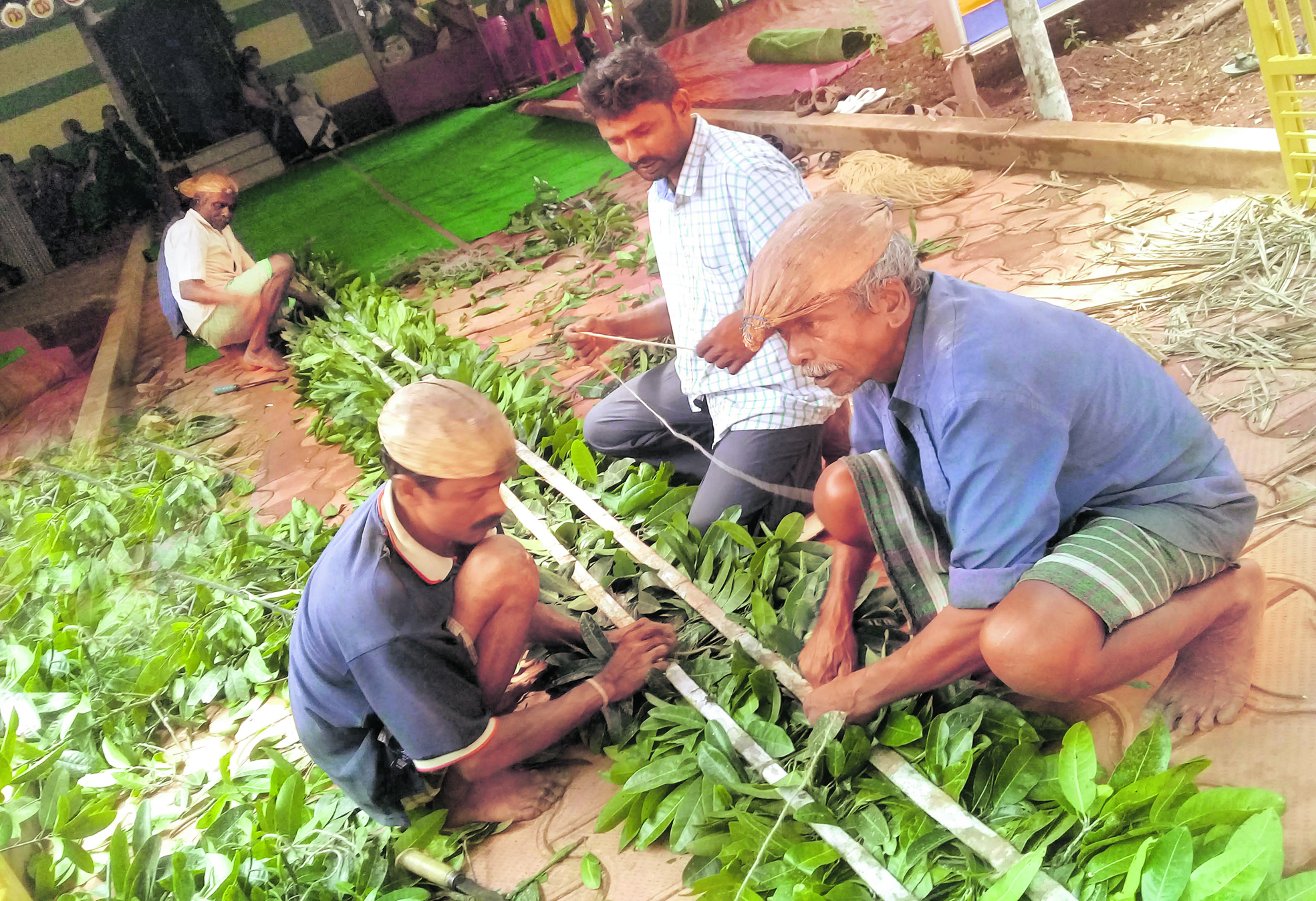 Artisans working on a traditional mantapa made of natural materials. Photos by author