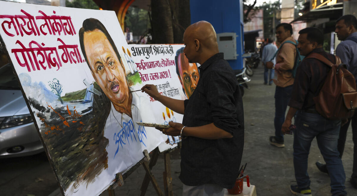 A teacher from Gurukul Art School pays tribute to Maharashtra Deputy Chief Minister Ajit Pawar by making paintings, in Mumbai.