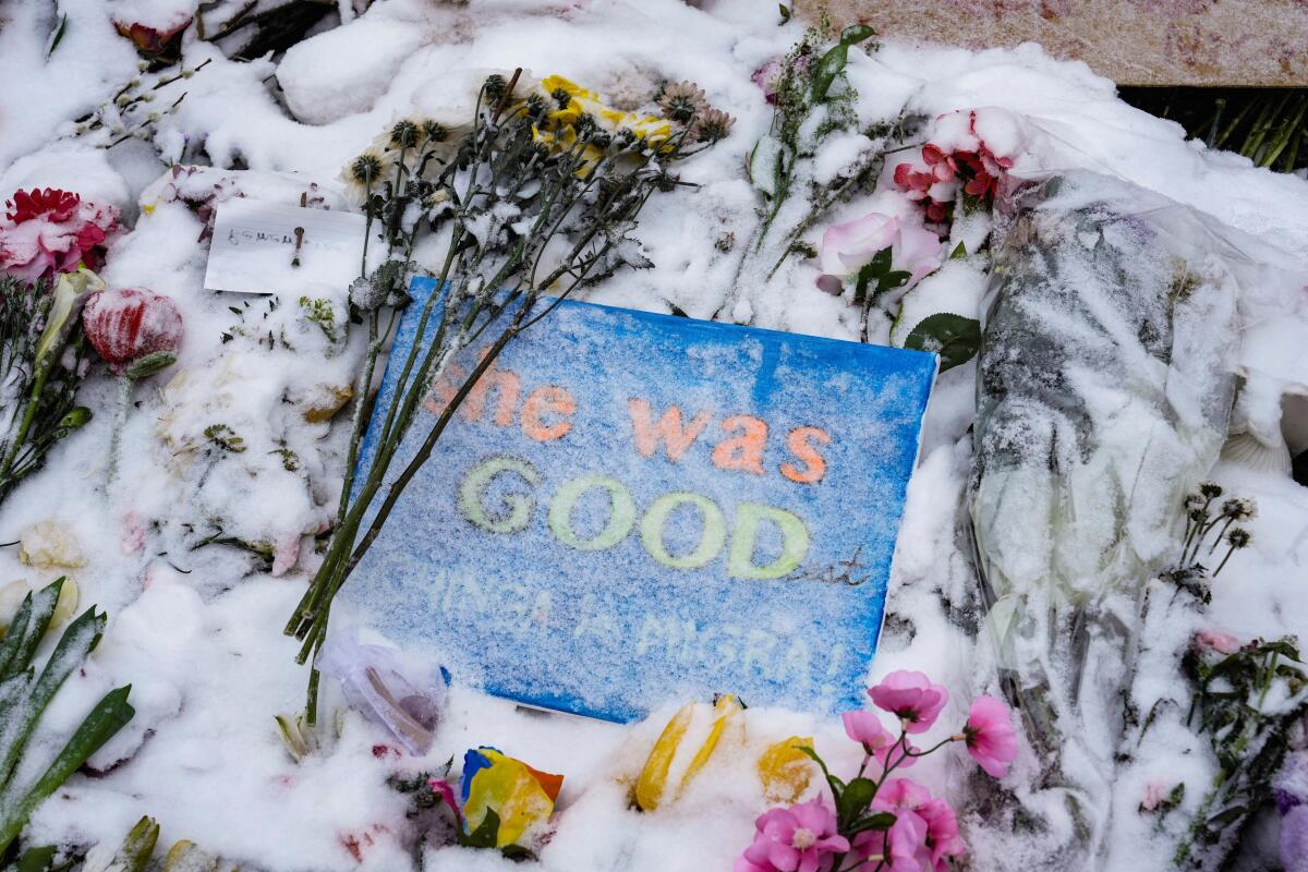 A sign and flowers sit during a memorial honouring Alex Pretti and Renee Nicole Good, who were fatally shot by federal immigration agents in separate incidents on January 24 and January 7, respectively, in Minneapolis, Minnesota, US.