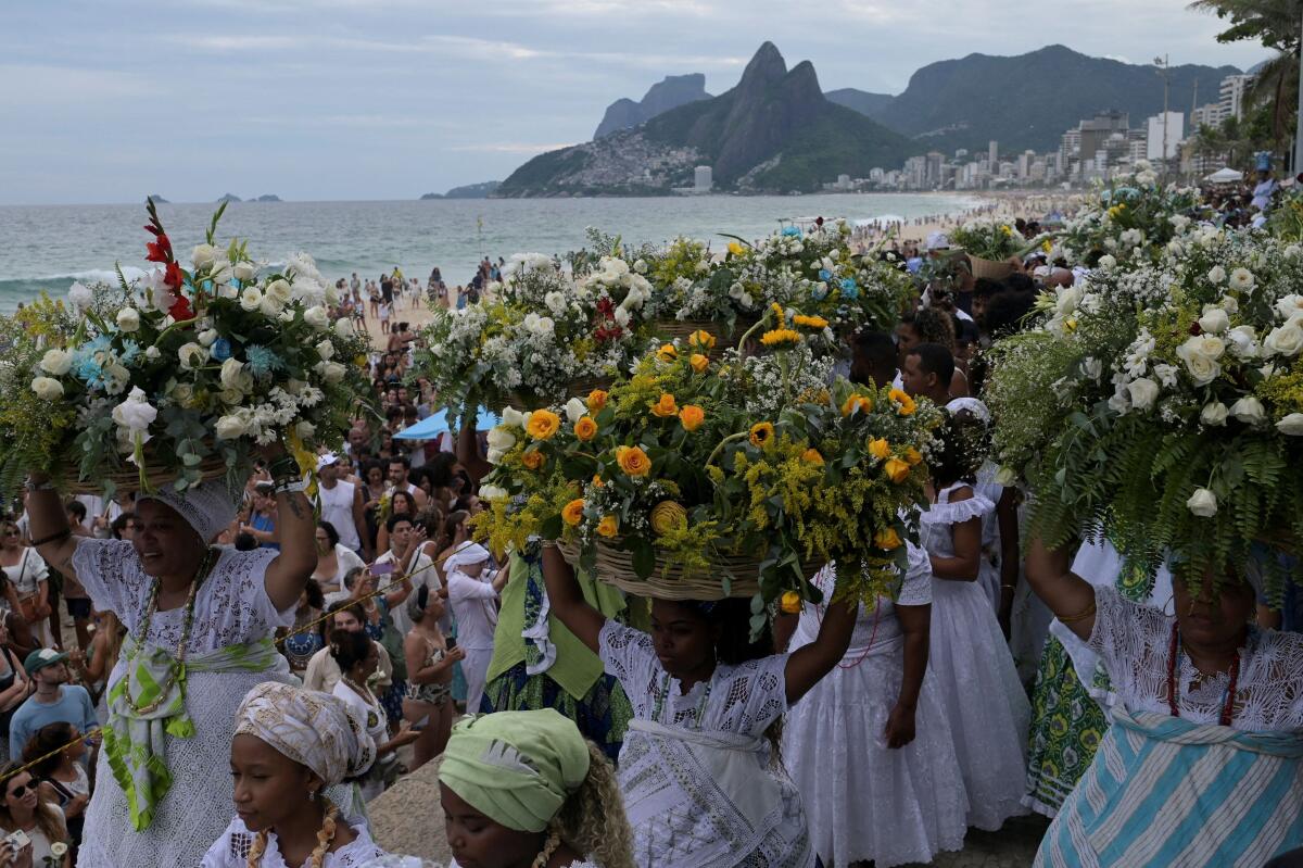 Worshippers take part in the traditional ceremony of Iemanja, the Goddess of the Sea in the syncretic Afro-Brazilian religion Umbanda, at the Arpoador beach in Rio de Janeiro, Brazil.