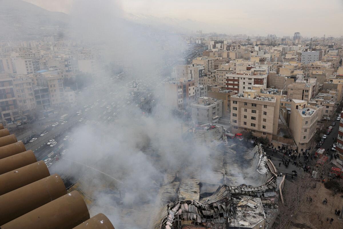 Smoke rises during a fire at Janat Abad Market in Tehran, Iran.