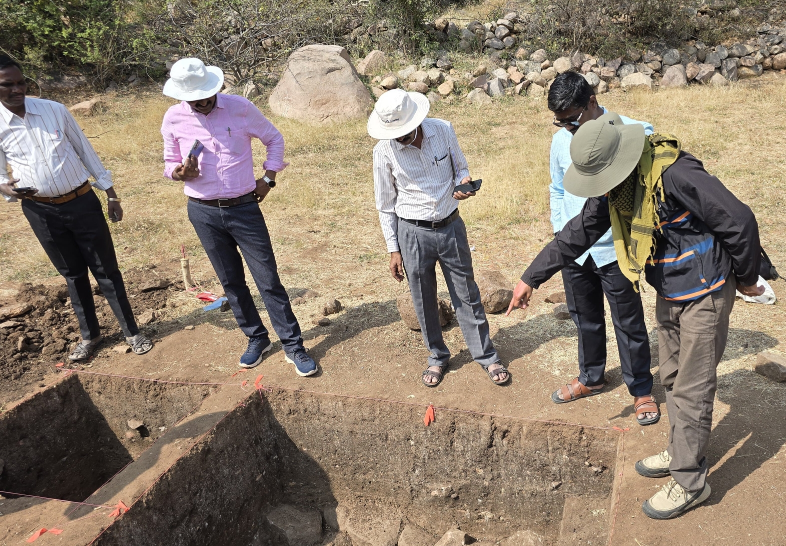 Deputy Director of Hampi-Kamalapur Archaeological Museums and Heritage department R Shejeshwara along with a team of archaeologists inspects an excavated site.