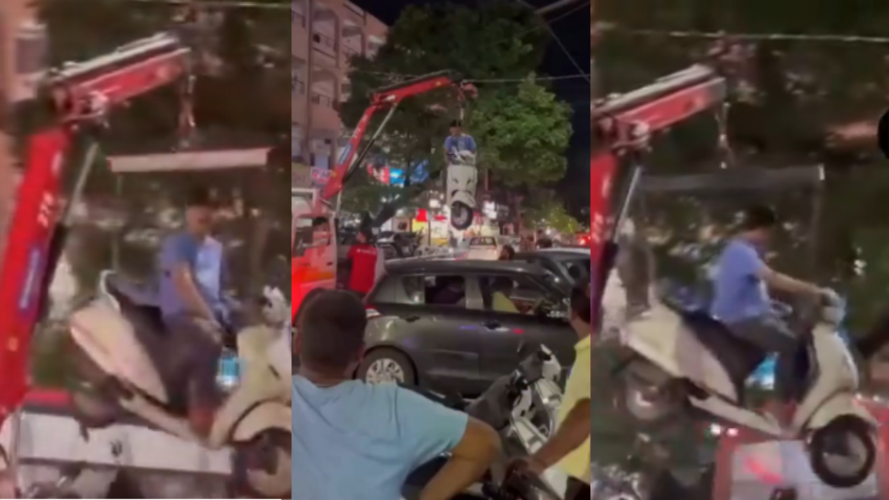 Watch: Pune man refuses to step down from towed scooter, gets lifted by crane in viral video