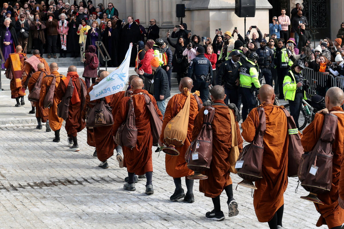 A group of Buddhist monks on the 2,300-mile "Walk for Peace" walk outside the National Cathedral in Washington, D.C., U.S., February 10, 2026.