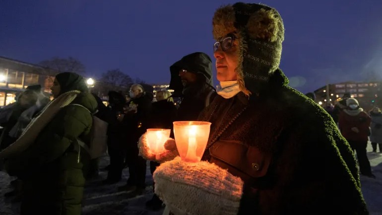 People take part in a vigil marking the fifth anniversary of the deadly shooting at the Quebec Islamic Cultural Centre, in Montreal on January 29, 2022.