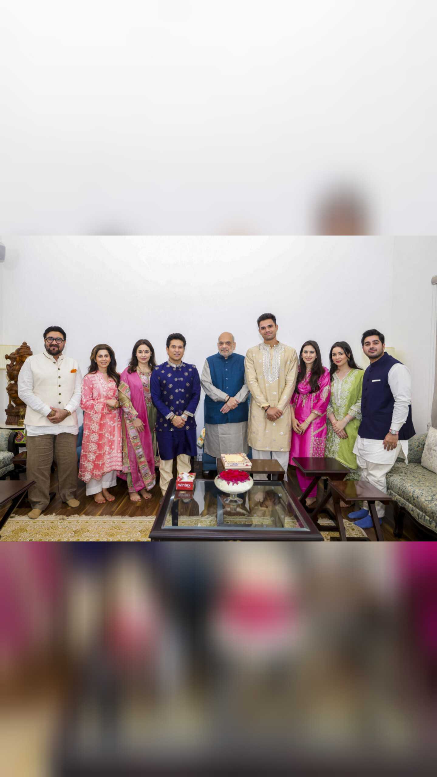 Union Home Minister Amit Shah with former cricketer Sachin Tendulkar, his wife Anjali Tendulkar, daughter Sara Tendulkar, son Arjun Tendulkar, his would-be wife Saaniya Chandhok and others during a meeting, in New Delhi. Shah was invited to Arjun and Saaniya's wedding.