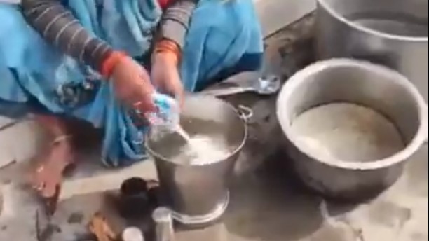 1 litre milk in bucket full of water served to students in mid-day meal at UP school